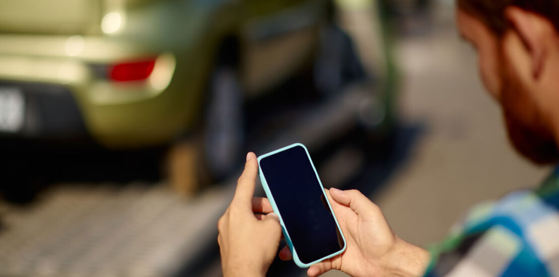 Man contacting a criminal lawyer as his car is towed for a criminal offence.