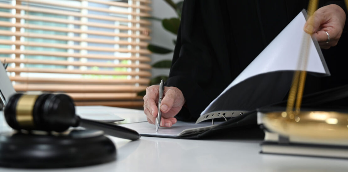 A judge reviewing a document for a pardon request after a DUI.