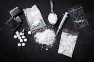 An assortment of drugs on a table, suggesting the need for a drug crime lawyer.