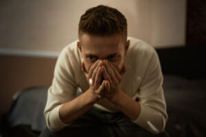 A distraught man facing assault charges in need of a criminal lawyer.