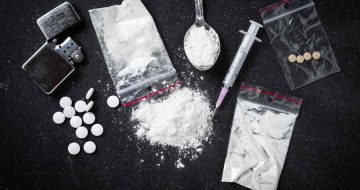 An assortment of drugs on a table, suggesting the need for a drug crime lawyer.